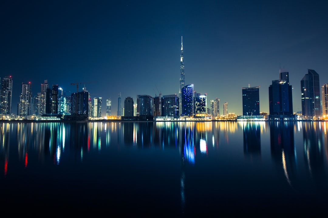 Business Bay towers reflected in the Dubai Water Canal at night